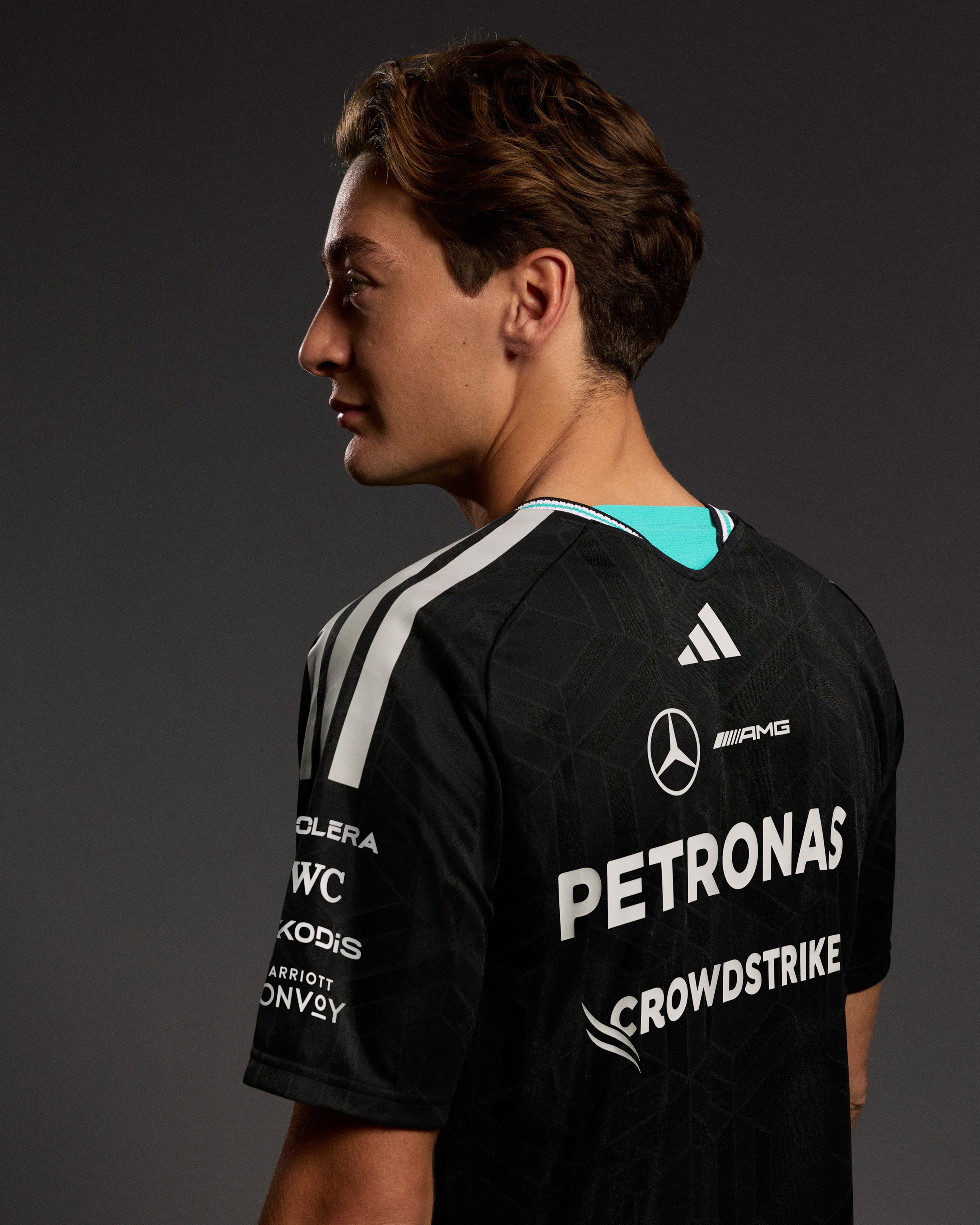 Mens 2026 Authentic Driver Tee Black — close-up design detail showing Mercedes-AMG PETRONAS F1 styling and product details | Dash Racegear