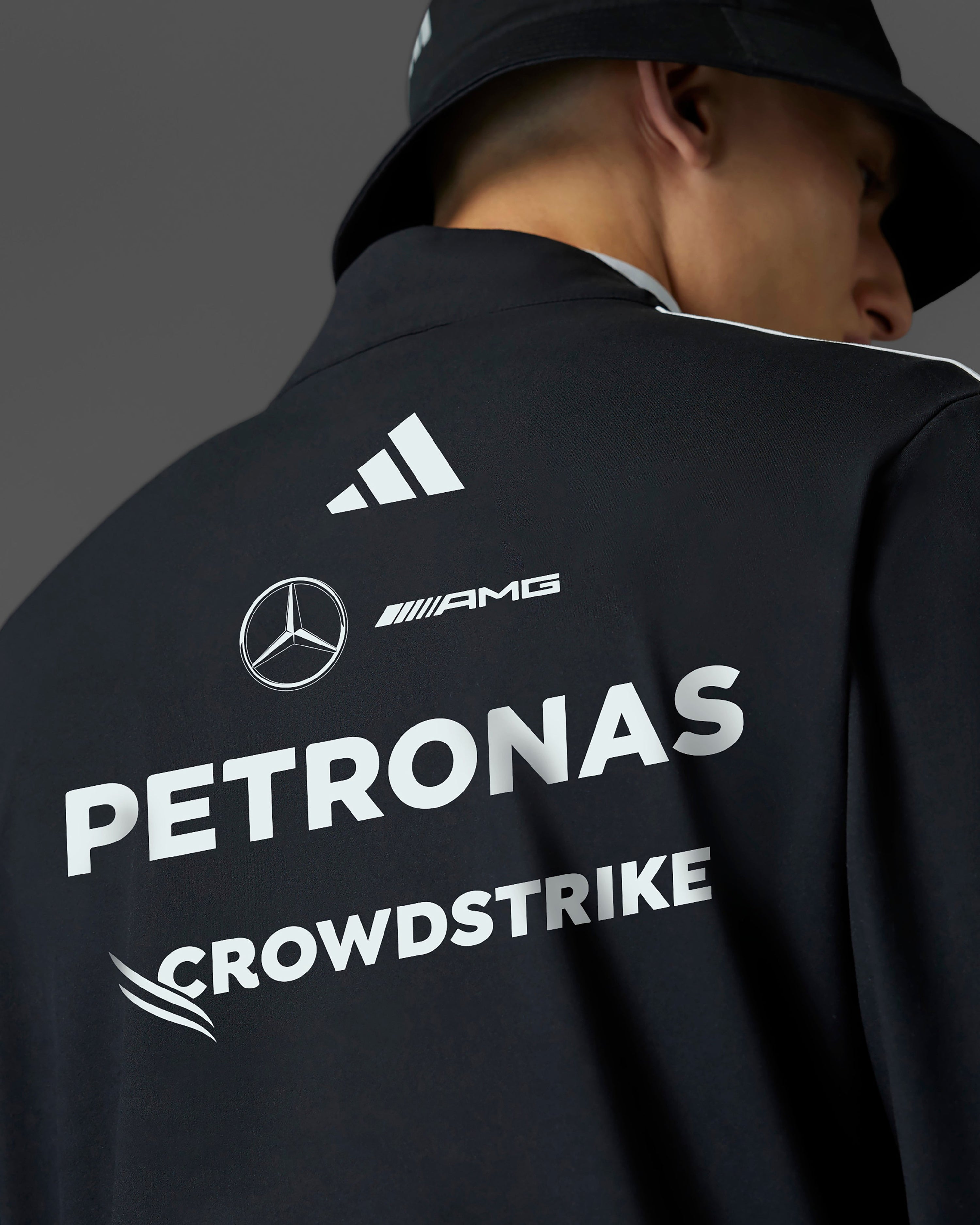 Mens 2025 Team Quarter Zip Black — close-up design detail showing Mercedes-AMG PETRONAS F1 styling and product details | Dash Racegear