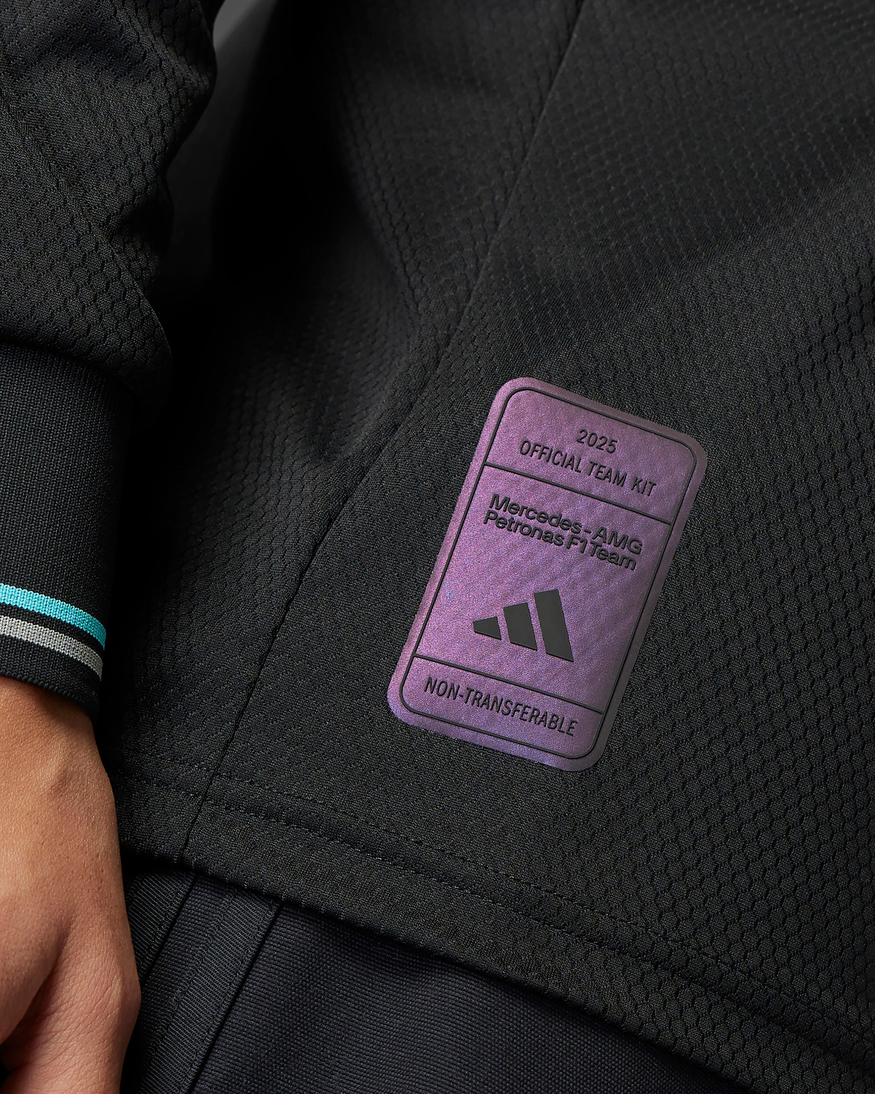Mens 2025 Authentic Long Sleeve Driver Tee Black — close-up design detail showing Mercedes-AMG PETRONAS F1 styling and product details | Dash Racegear