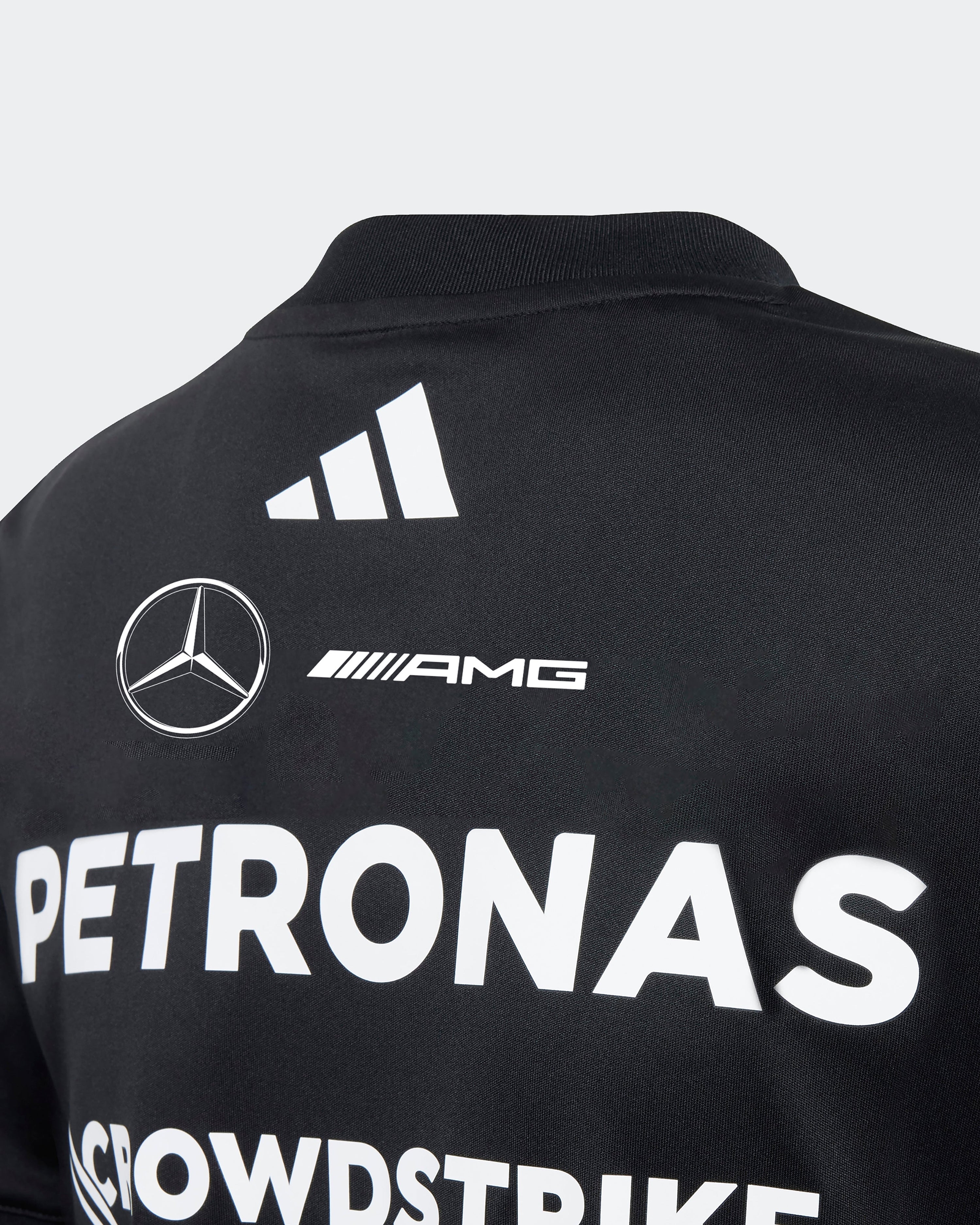 Kids 2025 Team Driver Tee Black — close-up design detail showing Mercedes-AMG PETRONAS F1 styling and product details | Dash Racegear