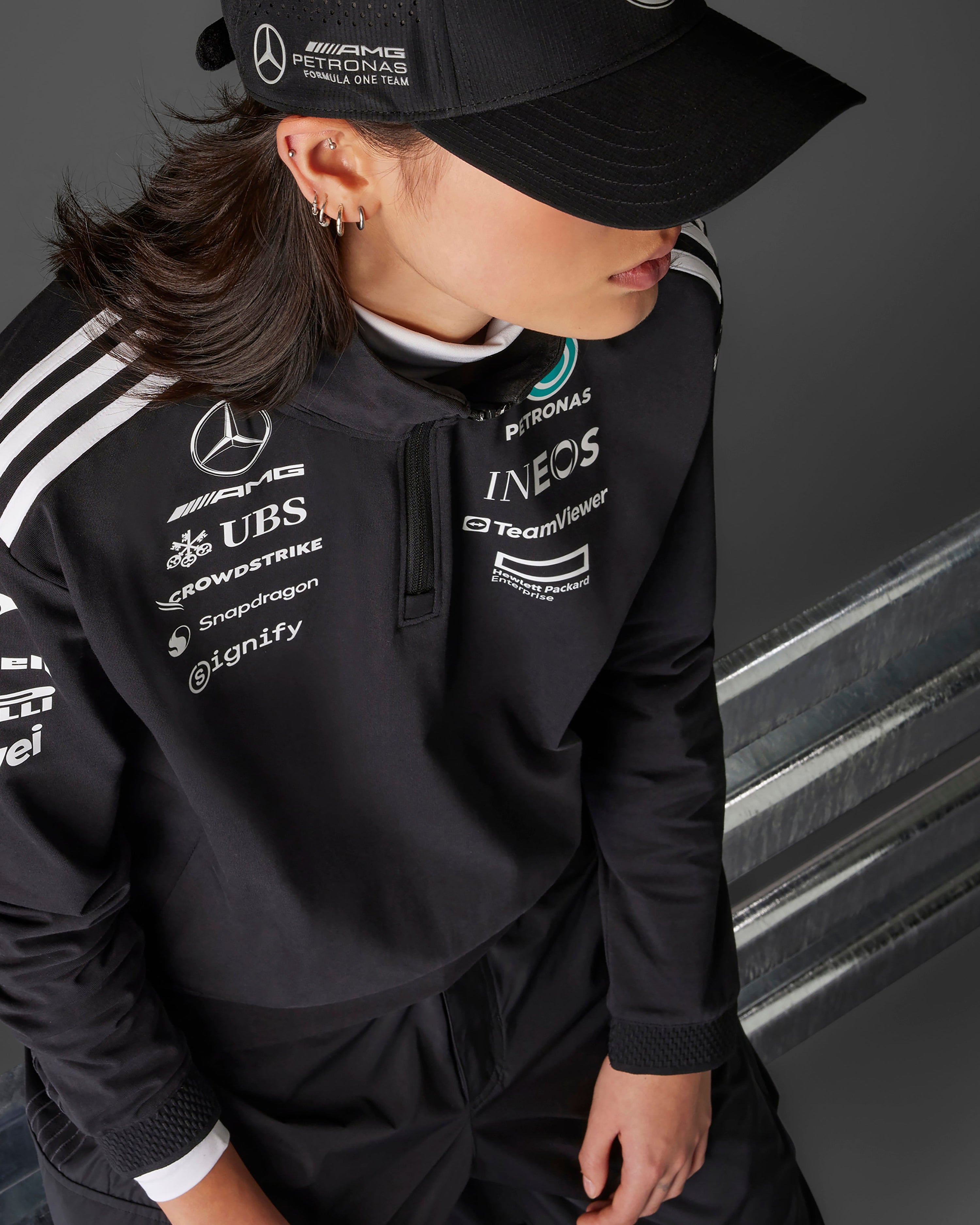 Womens 2025 Team Quarter Zip Black — close-up design detail showing Mercedes-AMG PETRONAS F1 styling and product details | Dash Racegear