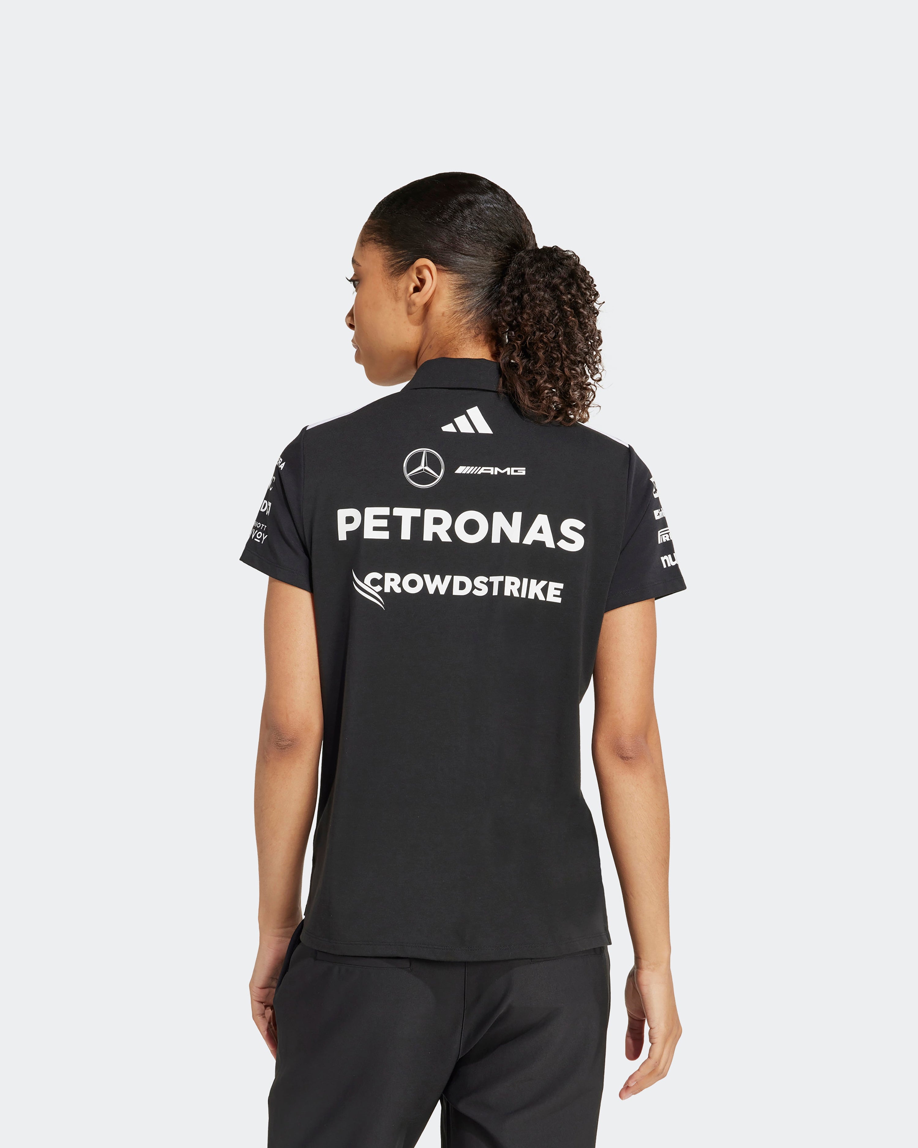 Womens 2025 Team Polo Black — close-up design detail showing Mercedes-AMG PETRONAS F1 styling and product details | Dash Racegear