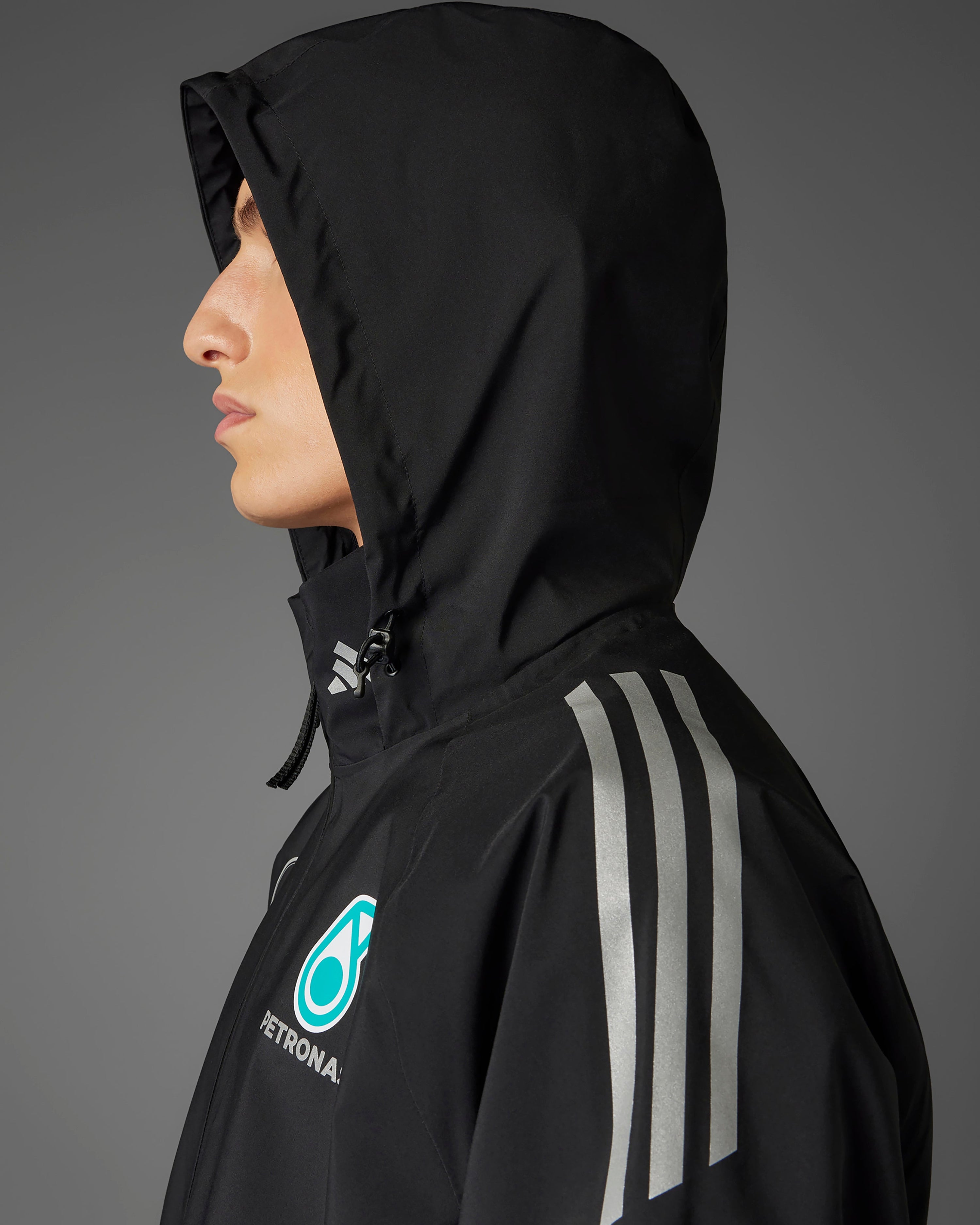 Mens 2025 Mechanics Rain Jacket Black — close-up design detail showing Mercedes-AMG PETRONAS F1 styling and product details | Dash Racegear
