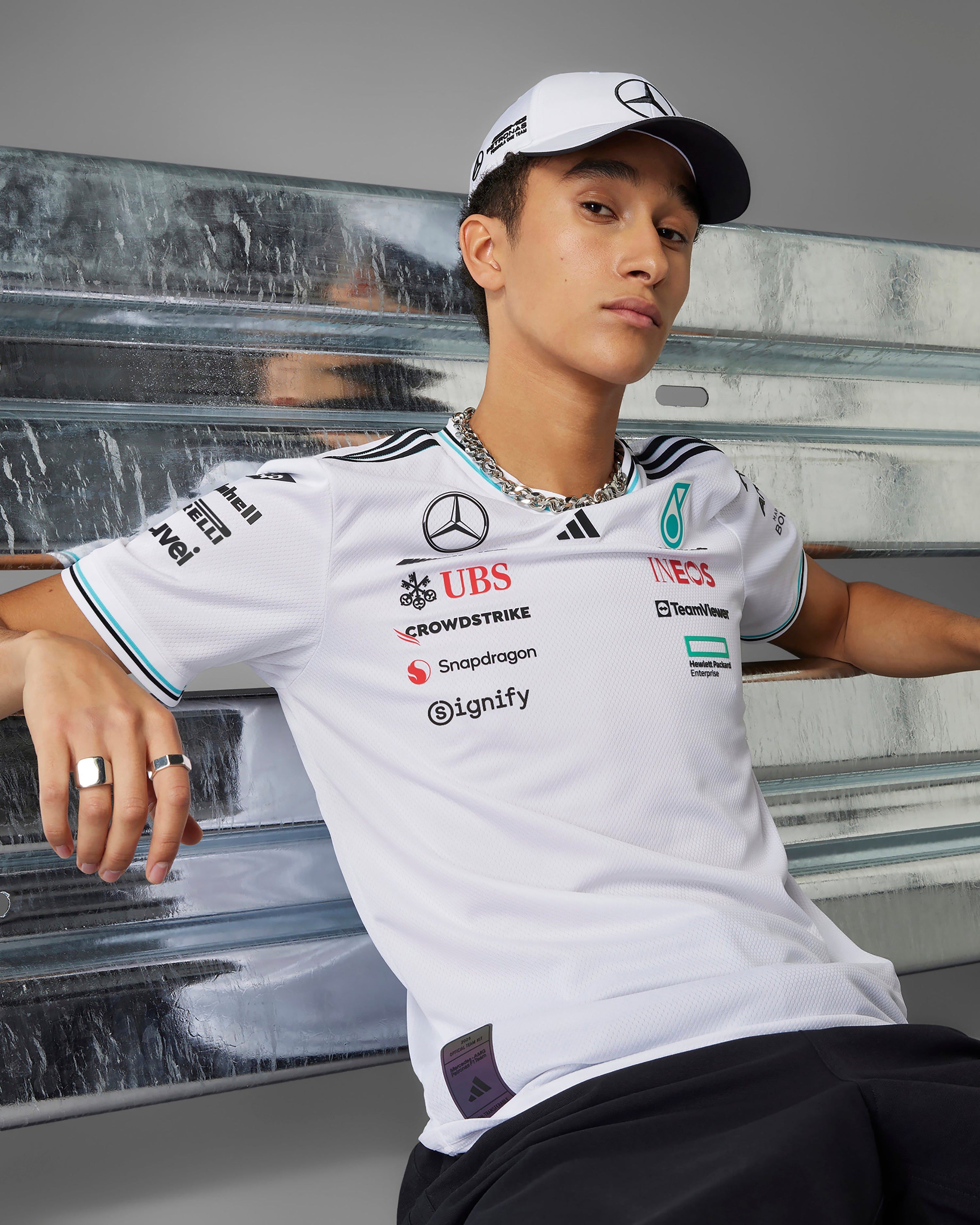 Mens 2025 Authentic Driver Tee White — close-up design detail showing Mercedes-AMG PETRONAS F1 styling and product details | Dash Racegear