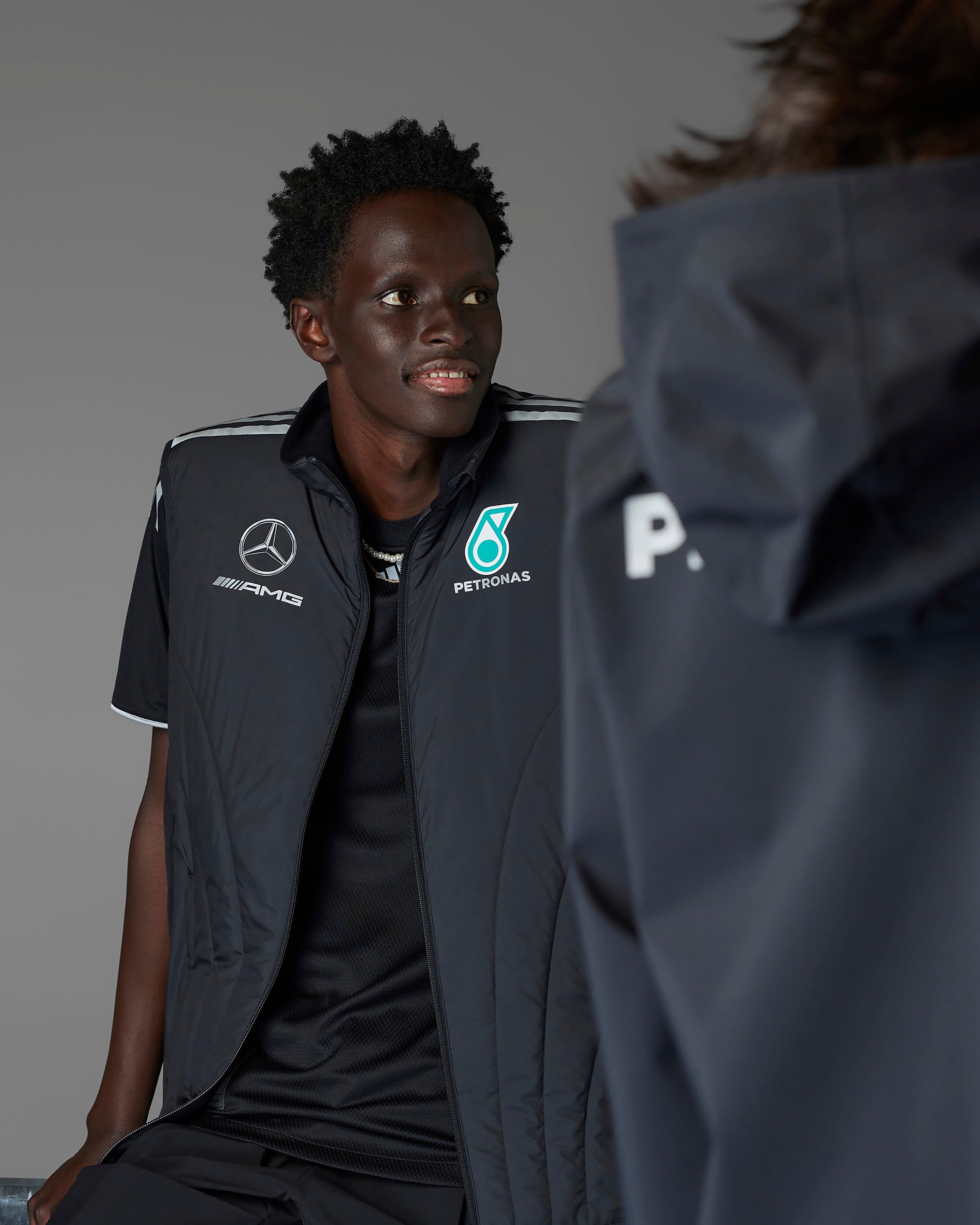 Mens 2025 Mechanics Vest Black — close-up design detail showing Mercedes-AMG PETRONAS F1 styling and product details | Dash Racegear