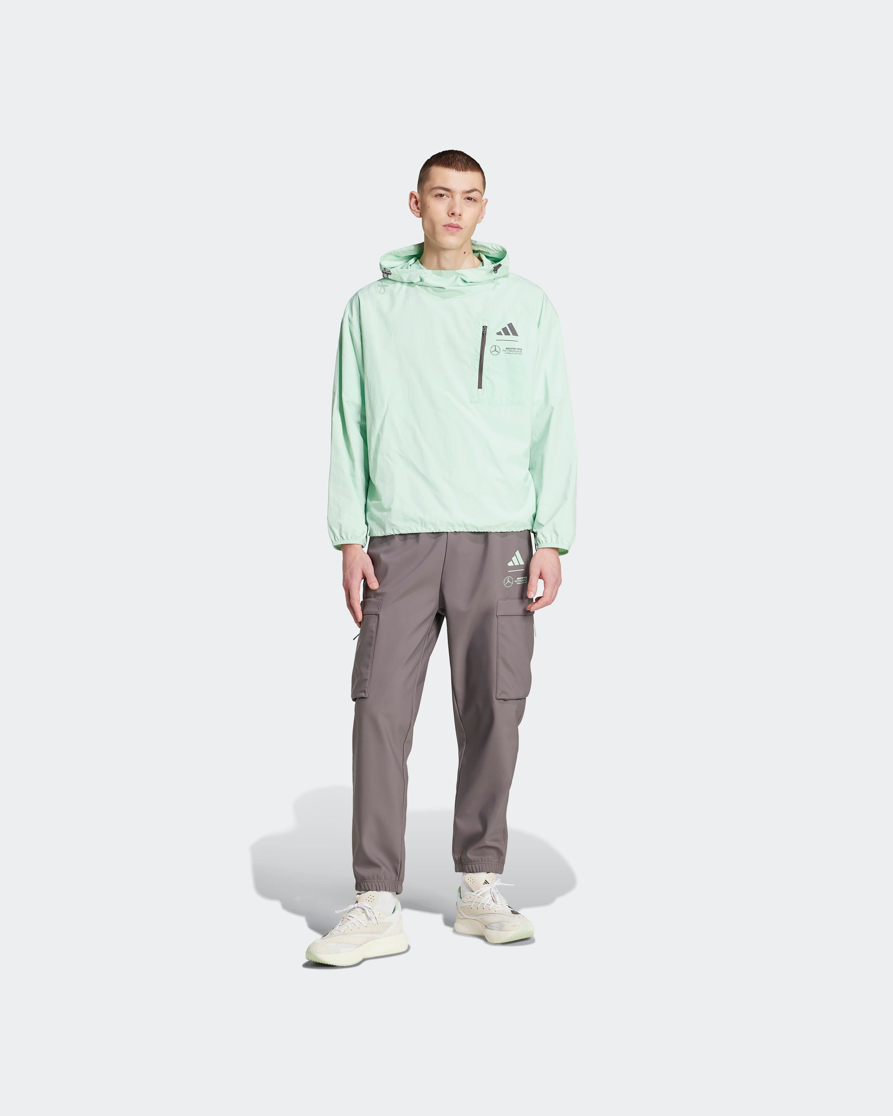 Mens Premium Woven Windbreaker Green — close-up design detail showing Mercedes-AMG PETRONAS F1 styling and product details | Dash Racegear