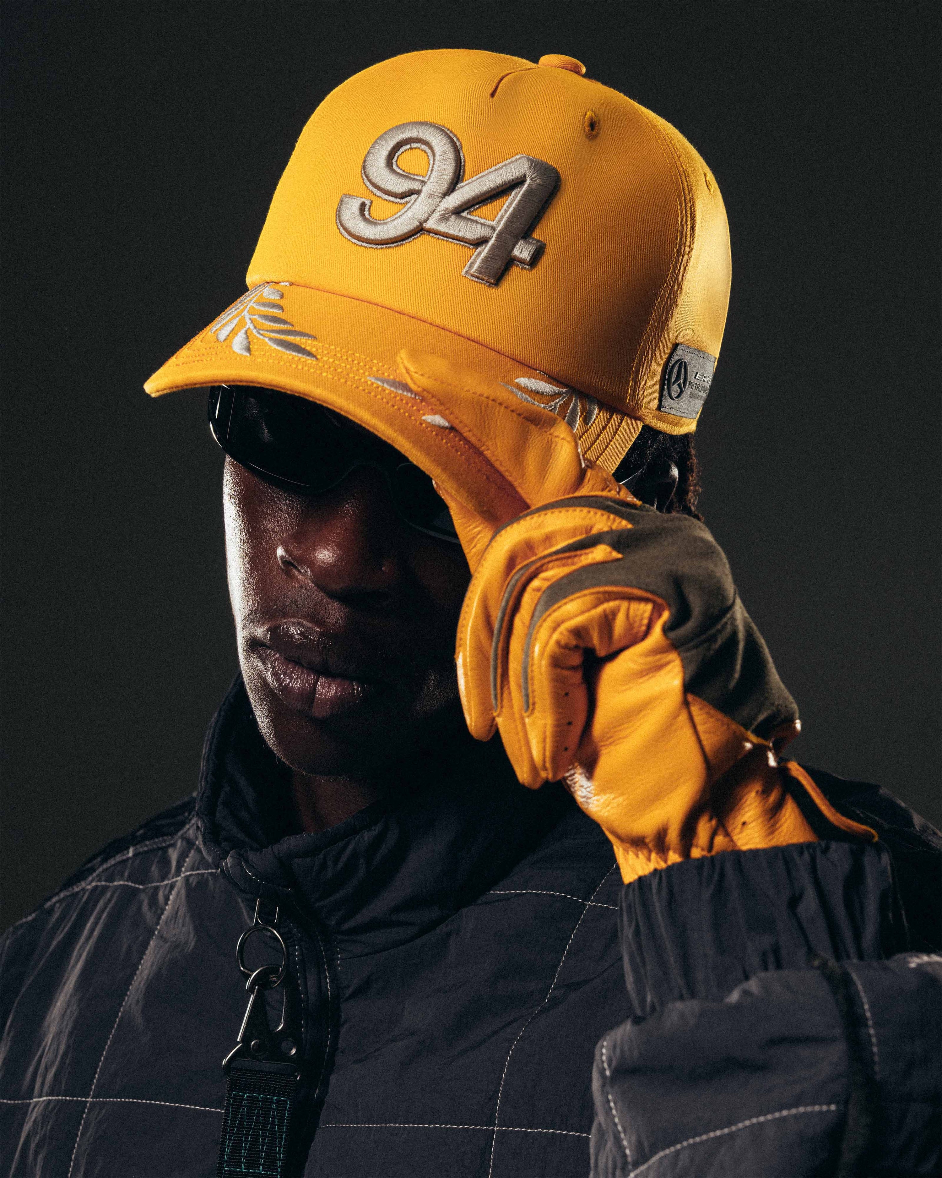 adidas para Bad Bunny x Mercedes-AMG F1 Racing Cap Gold — primary product view showing Mercedes-AMG PETRONAS F1 styling and product details | Dash Racegear