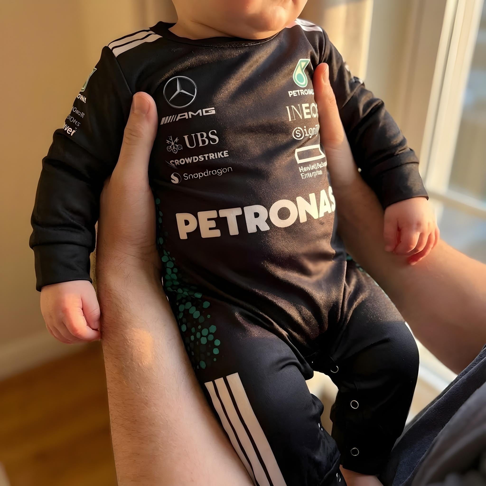 Mercedes Longsleeve Jumpsuit 2025 - parent holding a baby wearing a mercedes formula one baby onesie | Dash Racegear