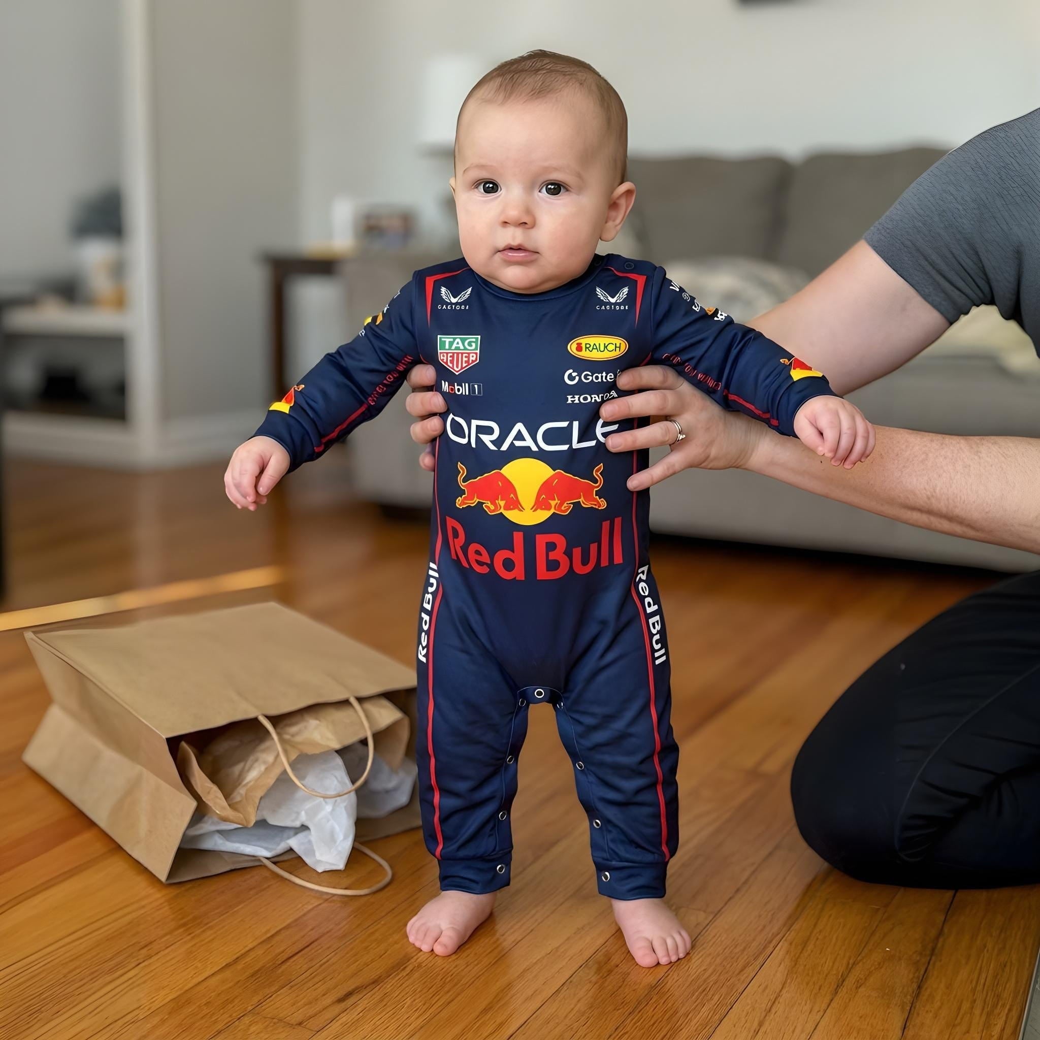 Red Bull Longsleeve Jumpsuit 2025 - toddler taking first steps in Red Bull Racing bodysuit | Dash Racegear